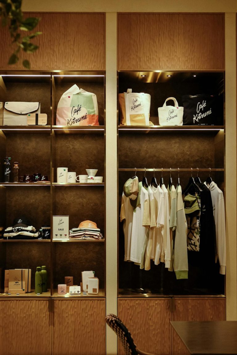 A stylish boutique display featuring clothing, bags, and accessories, offering a modern retail experience.