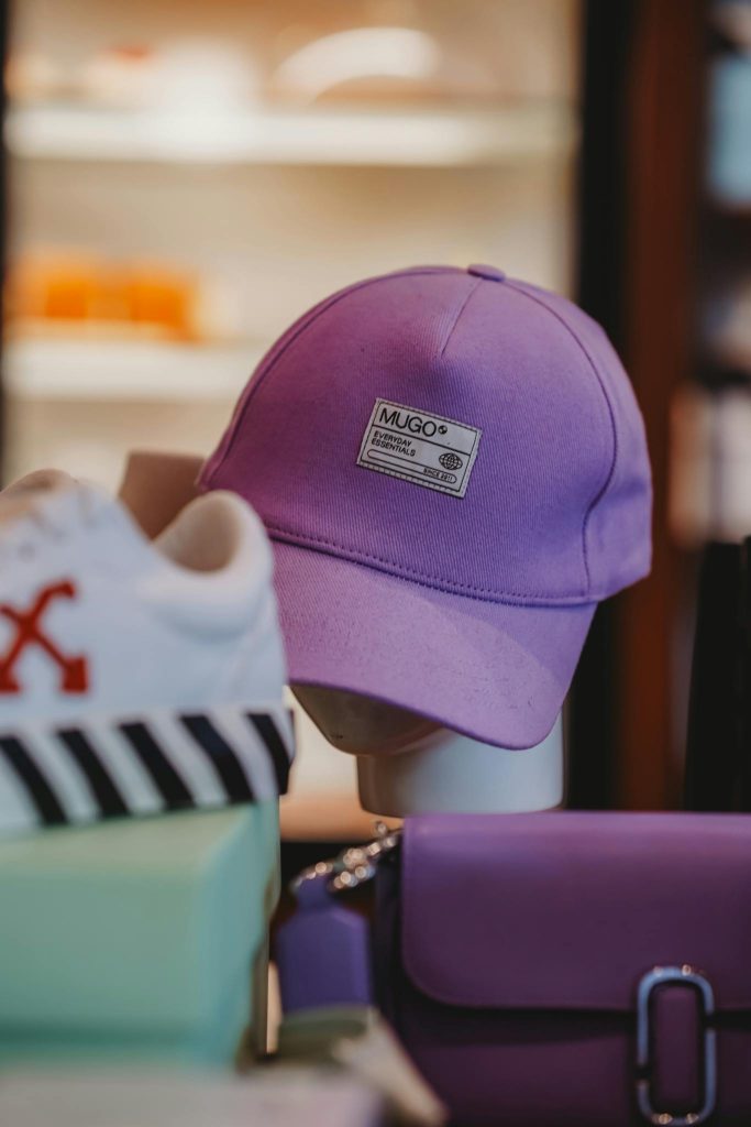 A stylish purple baseball cap showcased in an Ankara boutique store setting.